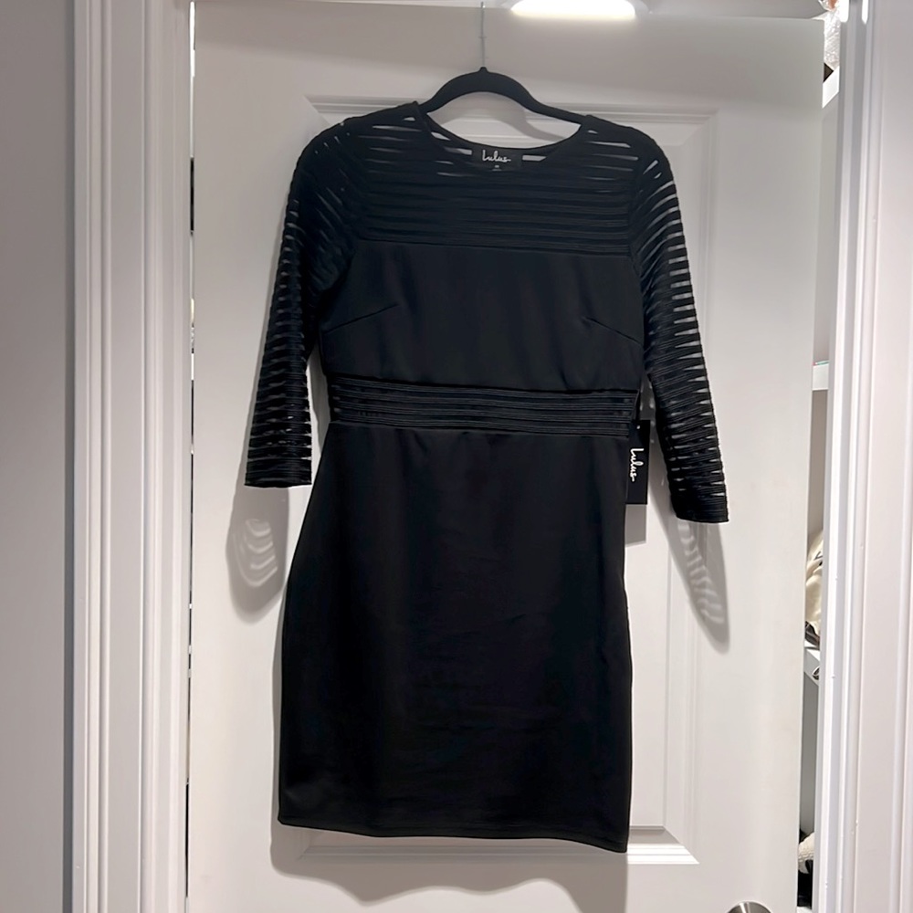 Fitted black dress with see through mid section and sleeves